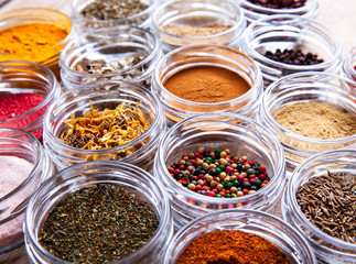 Spices in jars on wooden background. Food