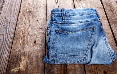 jeans stacked on a wooden background