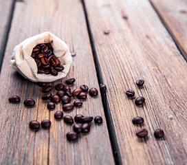 Coffee beans on the wooden background. Hot drinks.