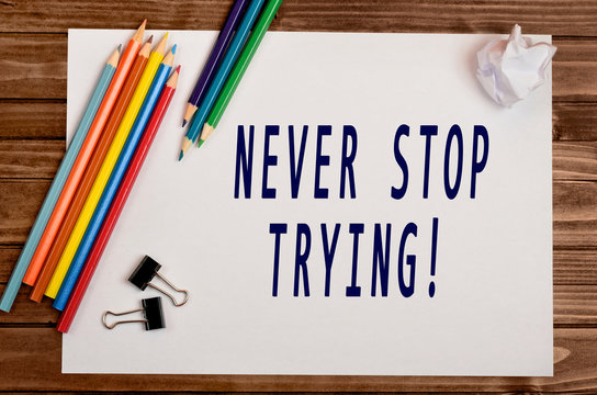 The words Never stop trying on paper