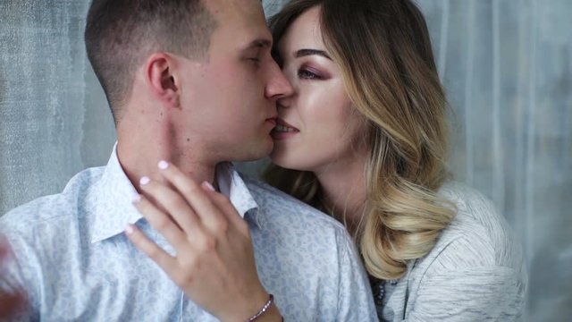 Happy young couple kissing and making selfie
