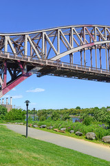 The Hell Gate Bridge (East River Arch Bridge) in New York City is a railroad only bridge, not used for passenger cars, and was a model for the Sydney Harbour Bridge in Australia