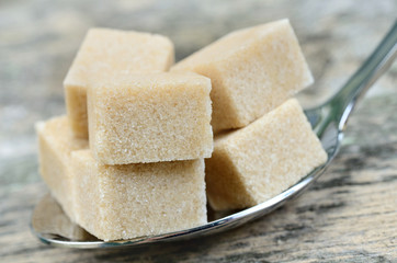 Sugar brown cubes in spoon