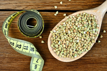 Obraz na płótnie Canvas Green buckwheat in spoon