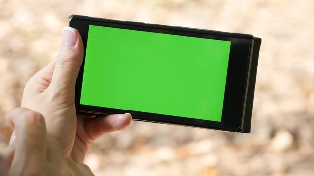 Business woman surfing on Internet green screen smart phone using 4K