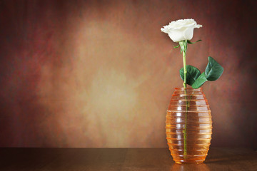 Still life with a single rose in the vase against brown background - Powered by Adobe