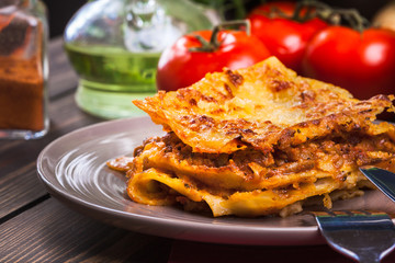 Piece of tasty hot lasagna on a plate