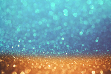 Golden and blue glitter bokeh background. Shiny holiday background. Wallpaper for web design