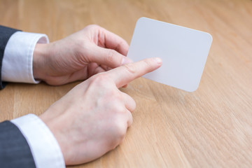 businessman holding white blank paper