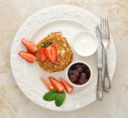 dessert of pancakes with raspberries and sour cream