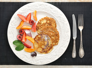 dessert of pancakes with raspberries and sour cream