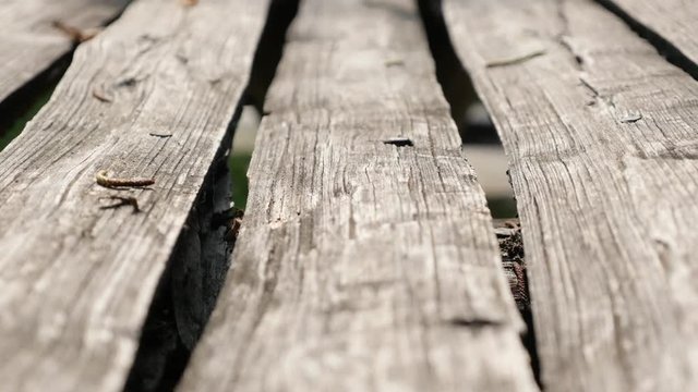 Rustic wooden garden table boards surface slow tilting 4K 2160p 30fps UltraHD video - Outdoor wooden plank made table slow tilt 4K 3840X2160 UHD footage
