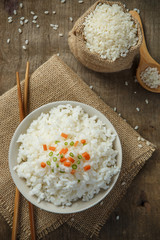Cooked rice with chopsticks on a sack