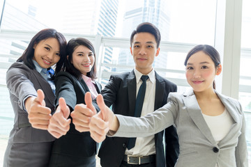 Group of business people showing thumb up together