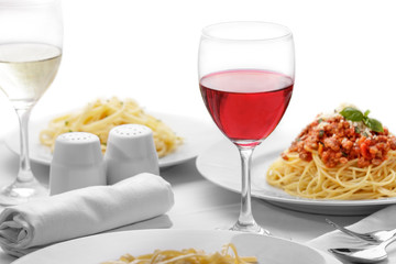 a glass of red wine served with italian pasta