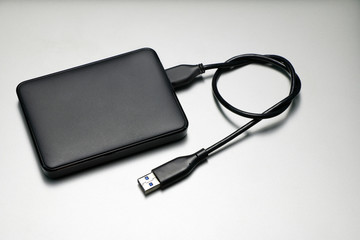 External hard drive for backup on gray background