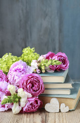 Old books and bouquet of flowers