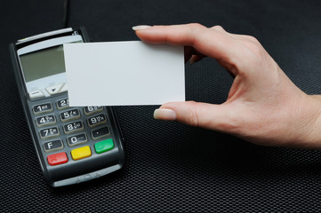 The girl holds in hand a credit card