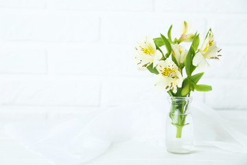 Beautiful alstroemeria flowers on a white wooden table