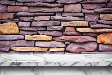 Empty white marble table on stone wall background.