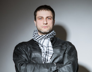 Portrait of a young man in biker's outfit