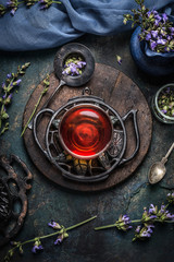 Cup of Healthy  herbal detox tea with sage leaves and flowers on dark rustic background, top view. Healthy drinks, detox or clean food concept