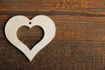 white decorative heart on a brown wooden background