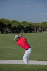 golfer hitting a sand bunker shot