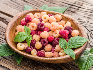 Raspberries in the wooden bowl.