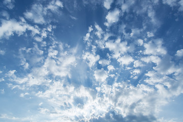 Sun rays in the cloudy sky.