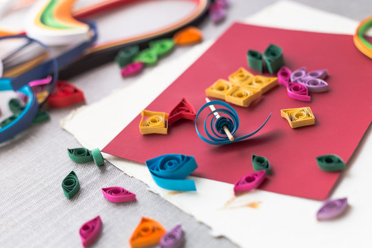 Handmade hobby: Preparing details for quilling, curling stripes of colored paper