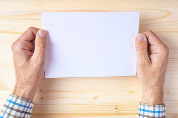 Fototapeta premium Man holding blank brochure as mock up copy space