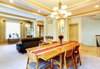 Cozy bright dining room connected with living room. View of entr
