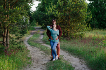 Happy couple on vacation. Lovers are laughing. Happy guy and girl. Lovers enjoy each other in the evening park.    