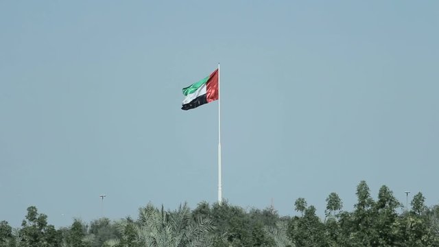A United Arab Emirates flag flying against clean and tranquil sky. UAE celebrates it's national day on 2nd December every year.