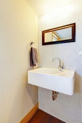 Naklejka na ściany i meble White hand wash basin in the corner with framed mirror