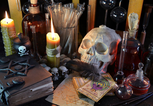 Still life with skull, tarot cards, candles and magic bottles