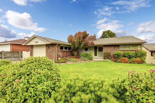 American rambler with nice front garden, well kept lawn and shru