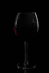 glass of red wine on black background.