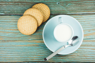 close-up of mug of milk and three cookies
