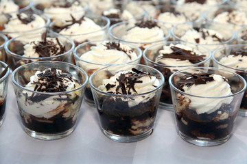 Whipped cream with chocolate on table in row