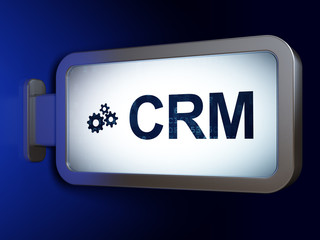 Business concept: CRM and Gears on billboard background