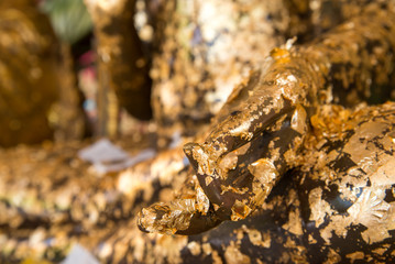 Hand of buddha covered in gold leaf