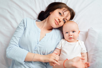 Top view closeup. Portrait of mother and baby looking at the cam