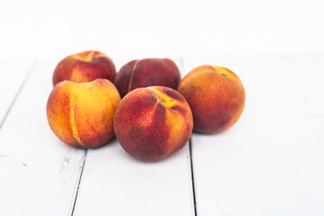 Ripe sweet cherries on white plate on painted wooden table