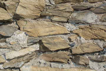 Stone Brick Wall made of fragment stones in irregular shapes
