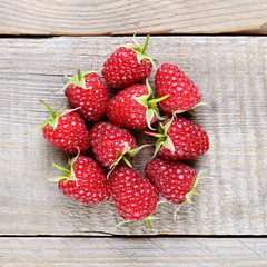 Raspberries on wooden table top view