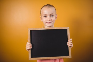 Little girl holding a blackboard 