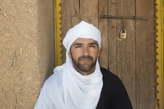 Bereber man next to the adobe wall. Ben Haddou, Morocco.