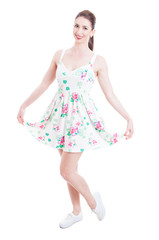 Naklejka premium Pretty lady smiling and posing in summer dress